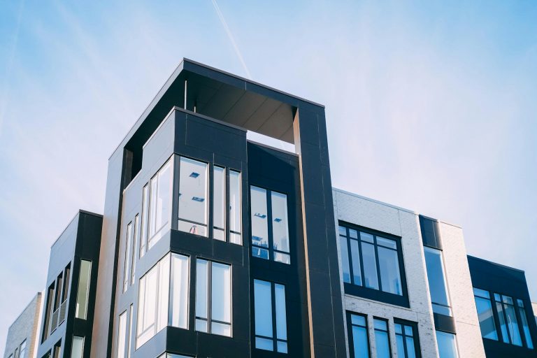 Modern multi-storey apartment building viewed from below