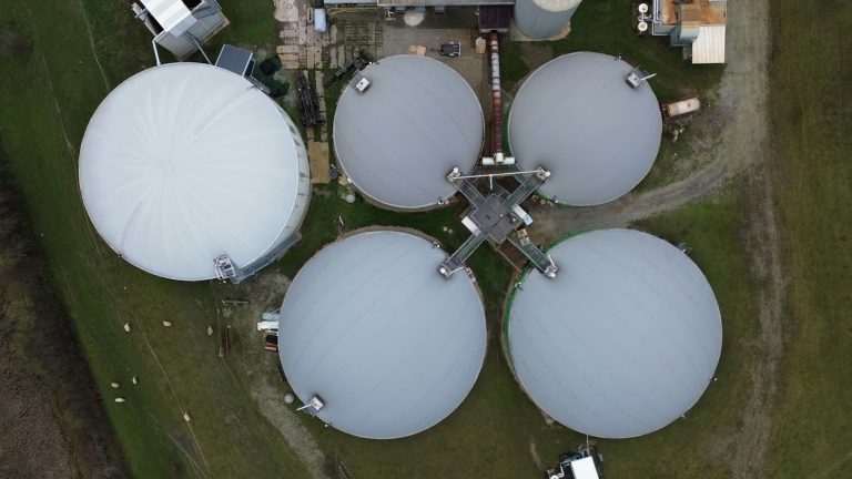 An aerial view of circular tanks at a biogas facility