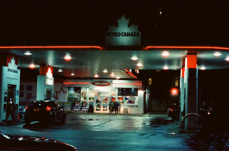 A Petro-Canada fuel station illuminated at night.