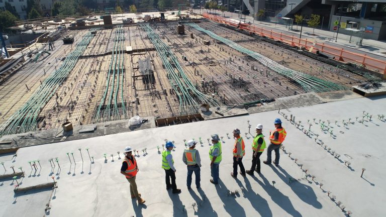 Construction workers standing on a large concrete building site