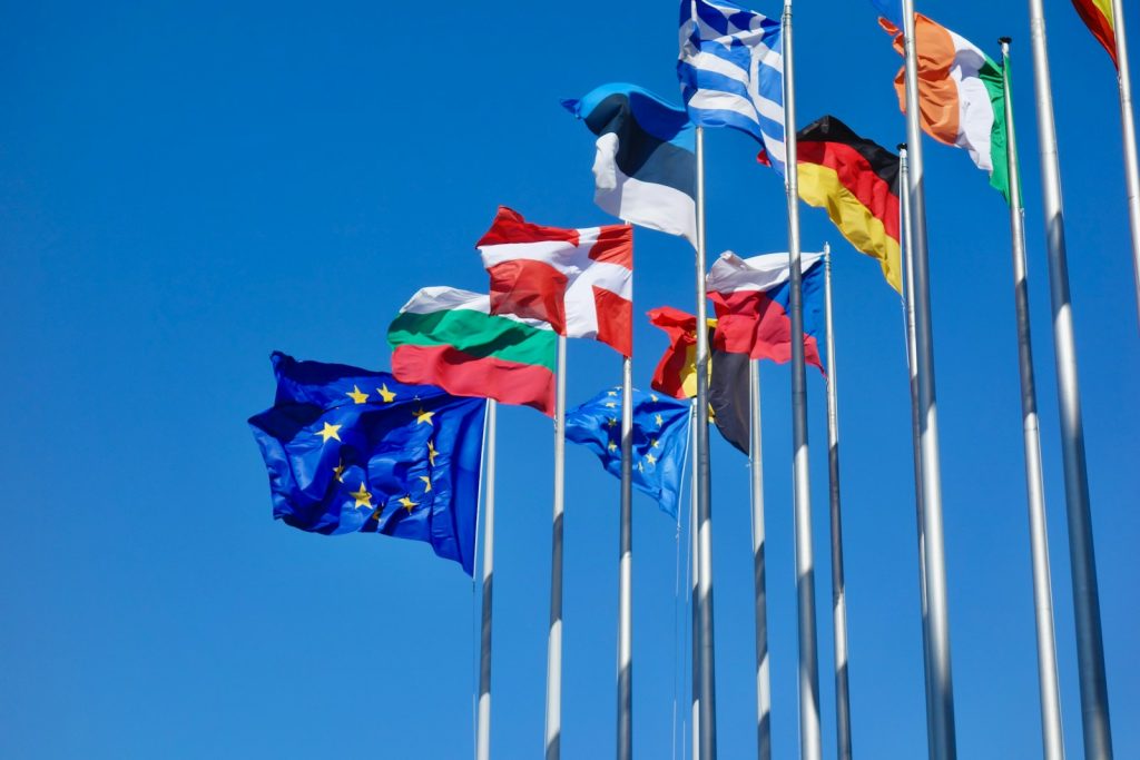 European national and European Union flags flying on flagpoles