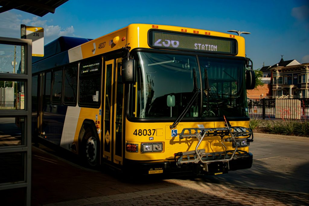 Low-floor public transit bus stopped on a city street, illustrative stock image