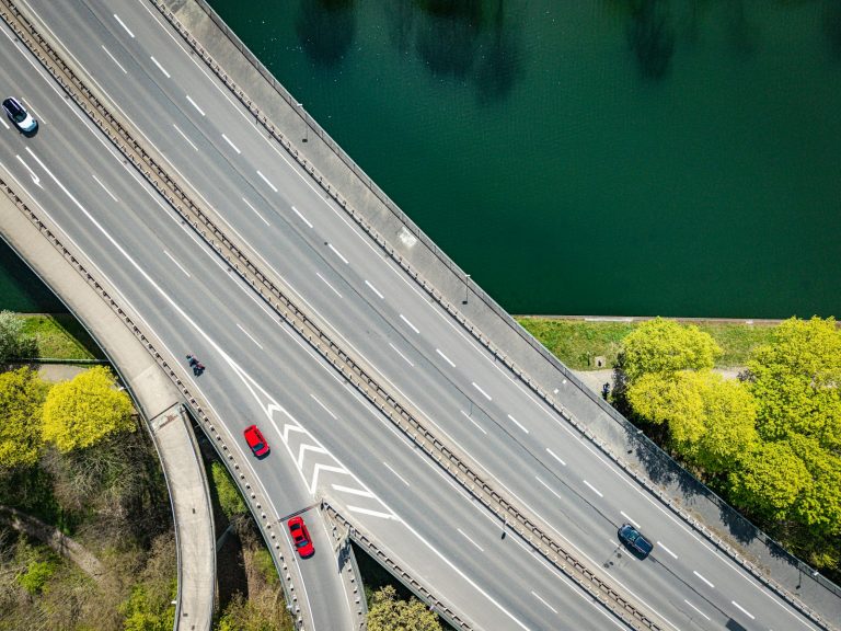 Aerial view of a highway interchange beside a river, illustrative stock image