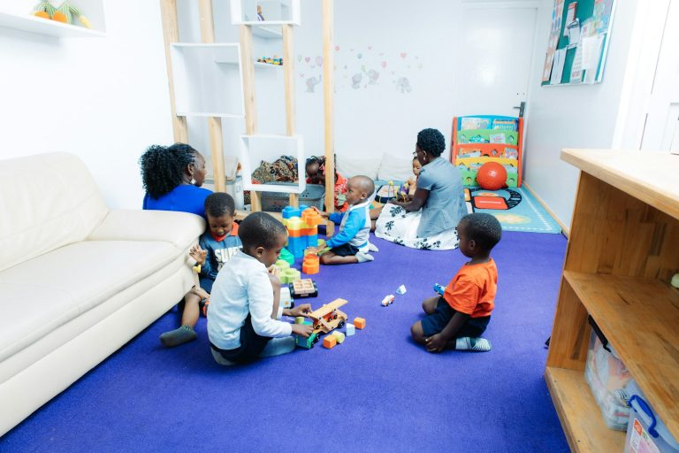 Children playing with colourful toys in a bright child-care room