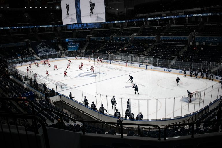 Ice hockey players warming up on a rink in an arena