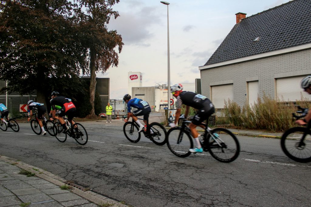 Road cyclists racing on a paved street, illustrative stock image.