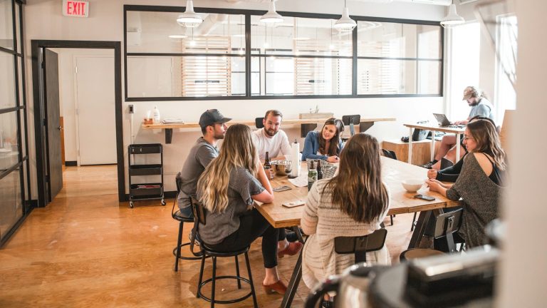 People collaborating around a table in a business meeting, illustrative stock image