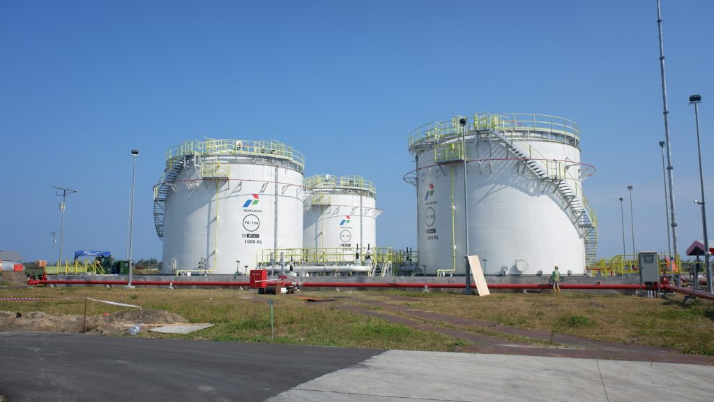Large white industrial storage tanks at a gas facility