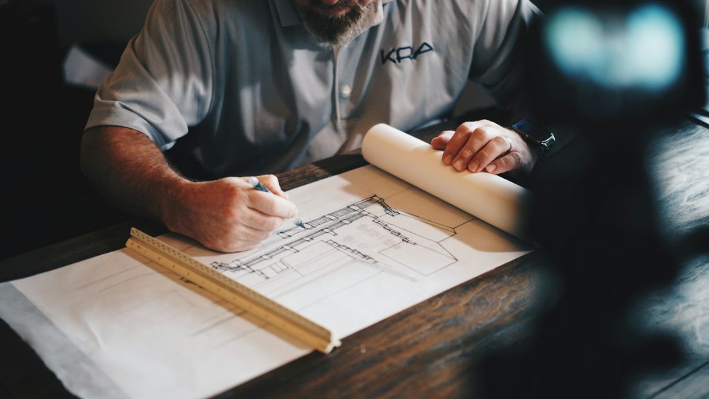 Architect drawing building plans at a work table