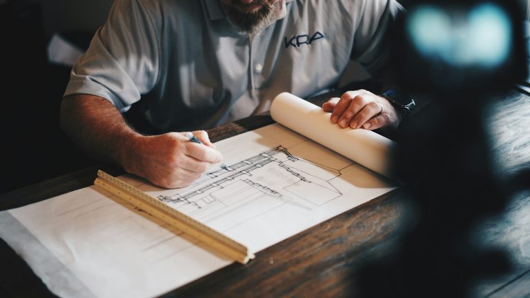 Architect drawing building plans at a work table