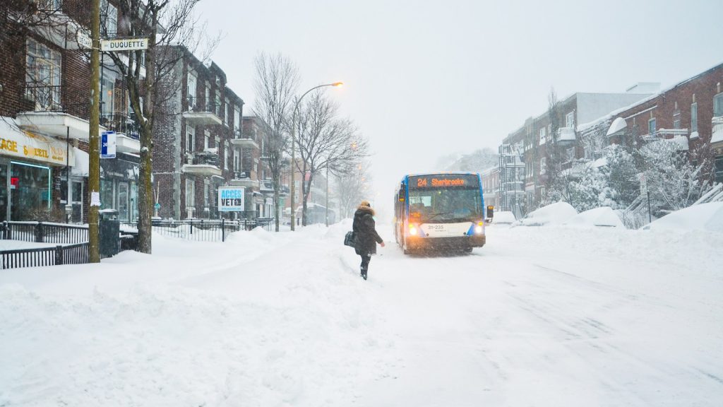 An STM bus travelling along a snowy Montréal street