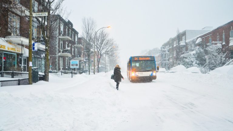 An STM bus travelling along a snowy Montréal street