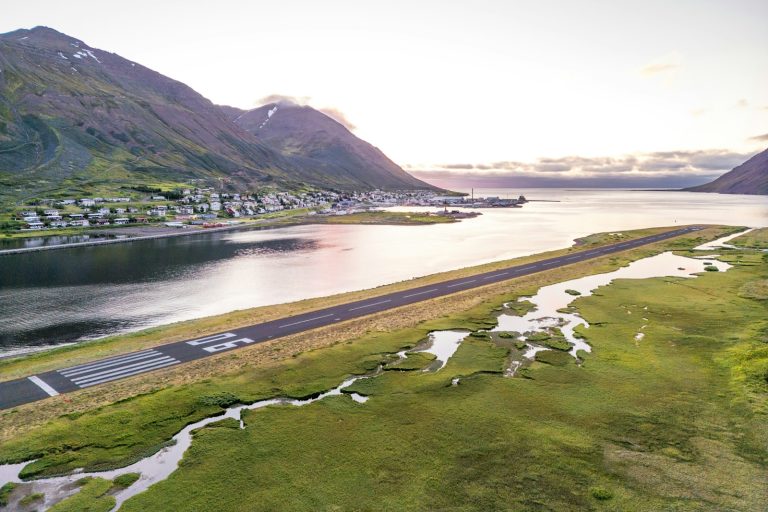 Airport runway beside a northern coastal community — illustrative