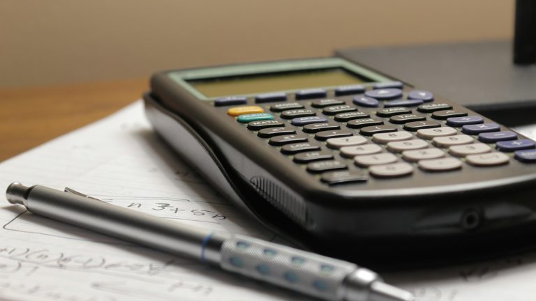 Calculator and pen on paperwork