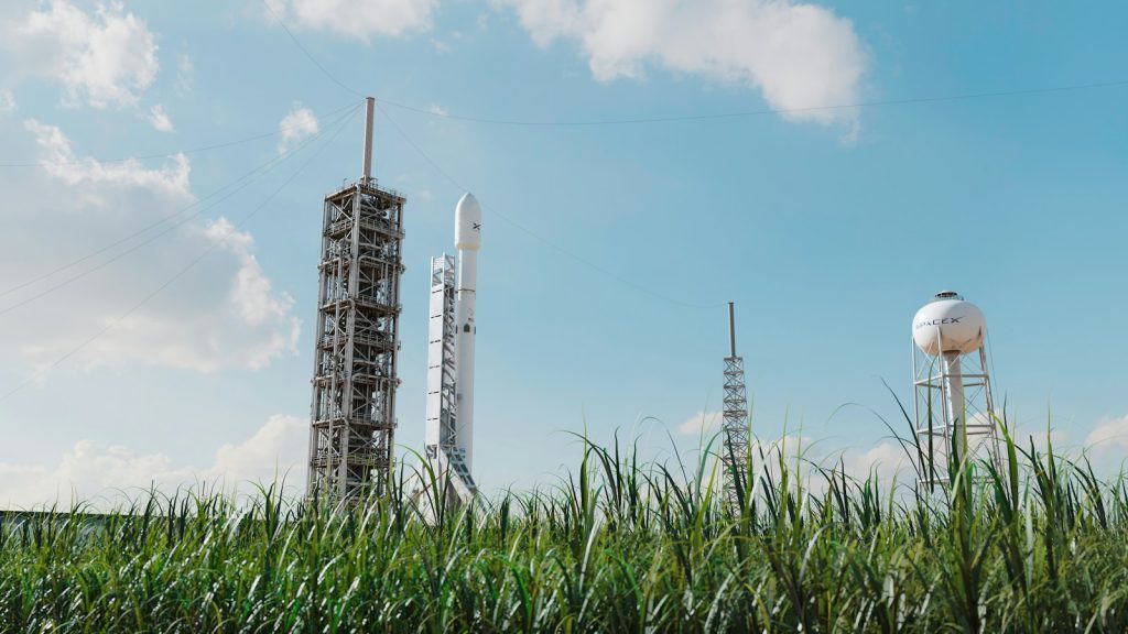 SpaceX rocket standing on a launch pad under a blue sky