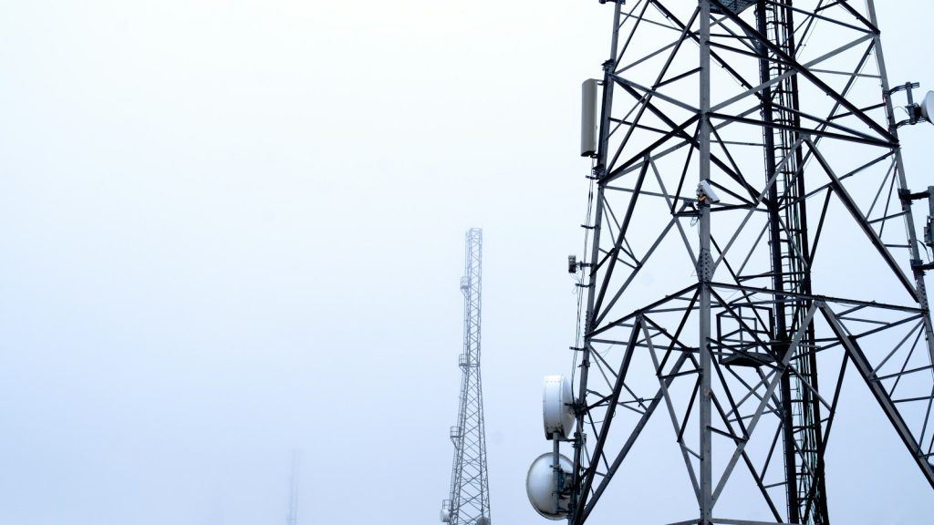 Telecommunications towers rising into fog