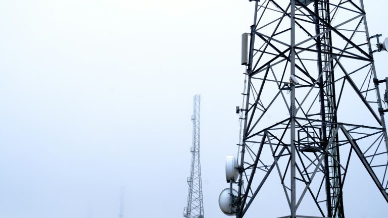 Telecommunications towers rising into fog