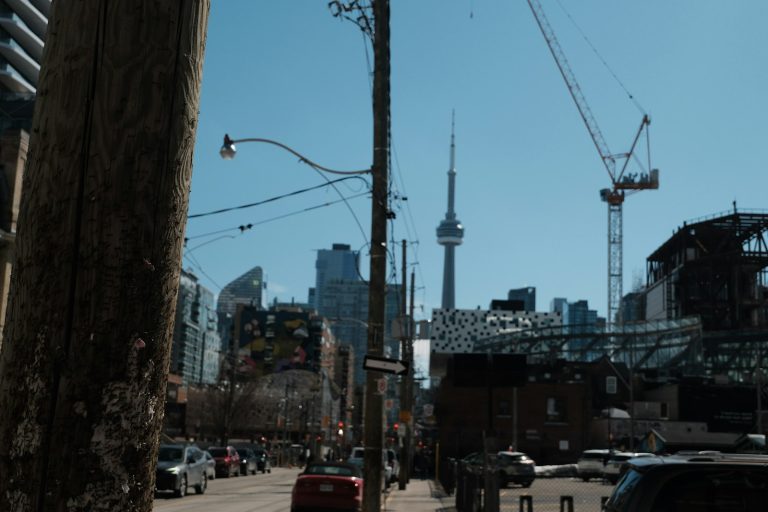 Construction cranes and the CN Tower in Toronto.