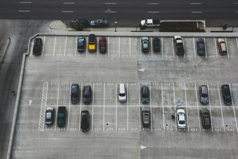 Aerial view of rows of vehicles in a large parking lot