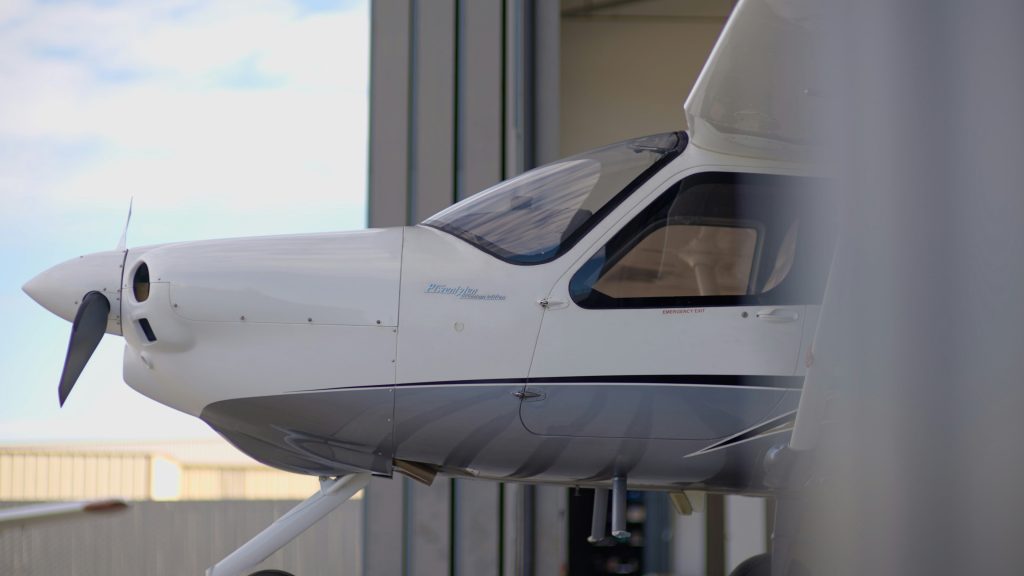 Aircraft parked inside a large maintenance hangar
