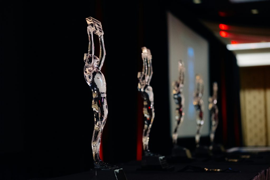 Clear award statuettes arranged in a row, illustrative image for Quebec awards
