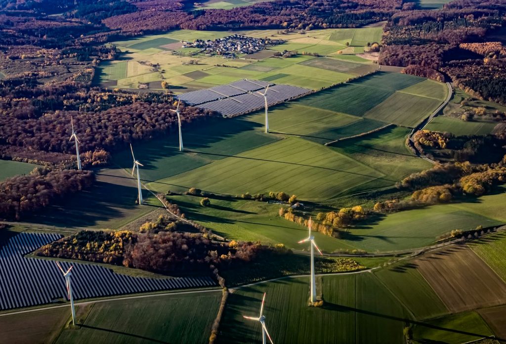 Wind turbines and solar panels in a rural landscape