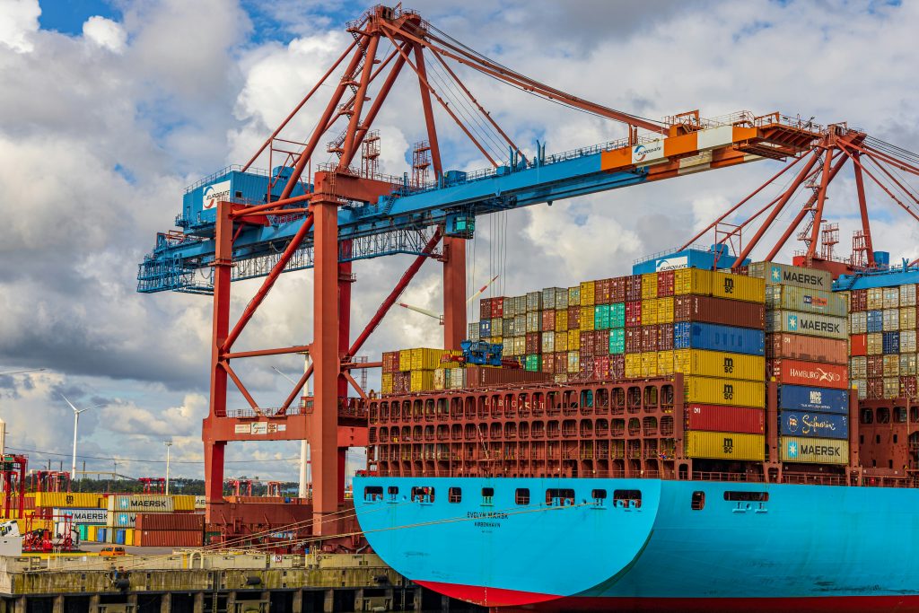 Container ship and cranes at a busy marine terminal