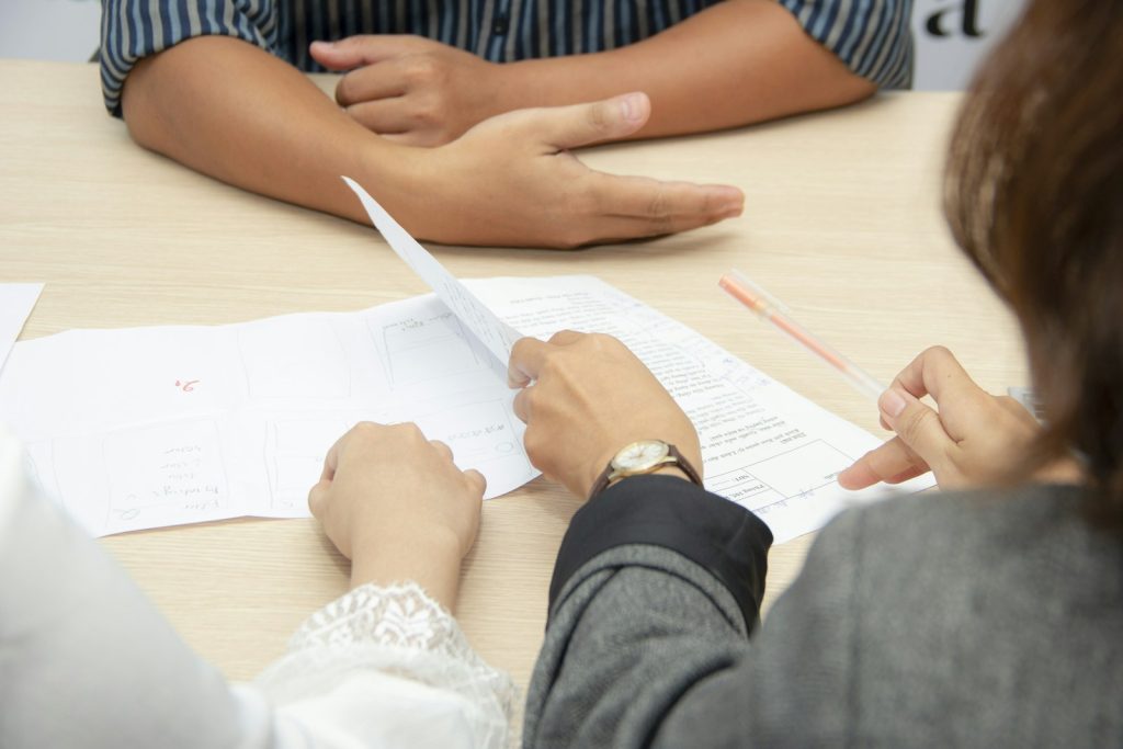 Two people reviewing documents during an interview, illustrating employment data