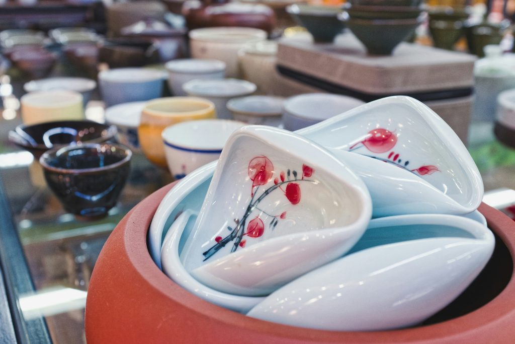 Colourful handmade bowls and dishes displayed at a market