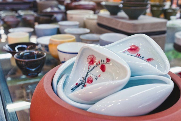 Colourful handmade bowls and dishes displayed at a market