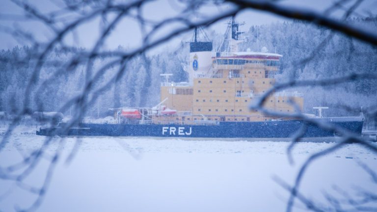 Icebreaker ship travelling through a frozen waterway