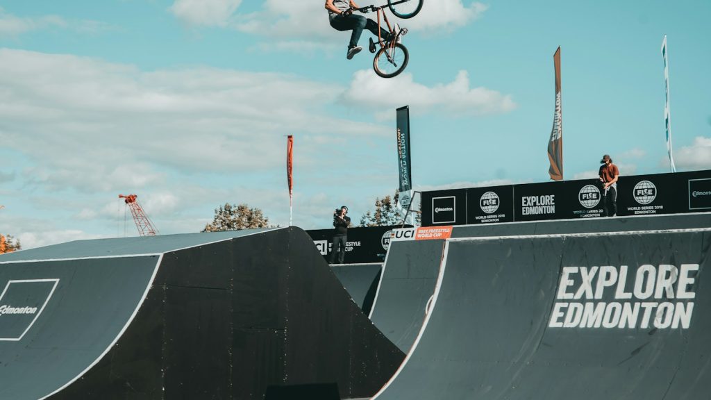 BMX rider airborne above a competition track