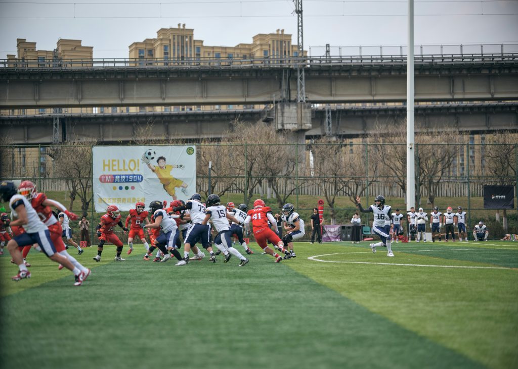 Football players in red and white uniforms during a game