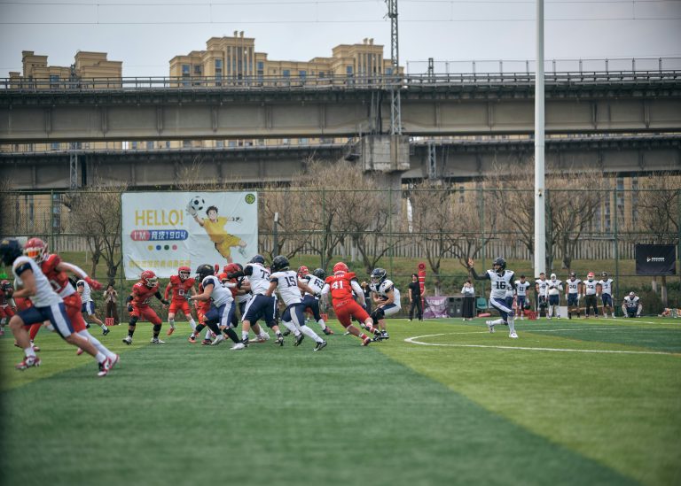 Football players in red and white uniforms during a game