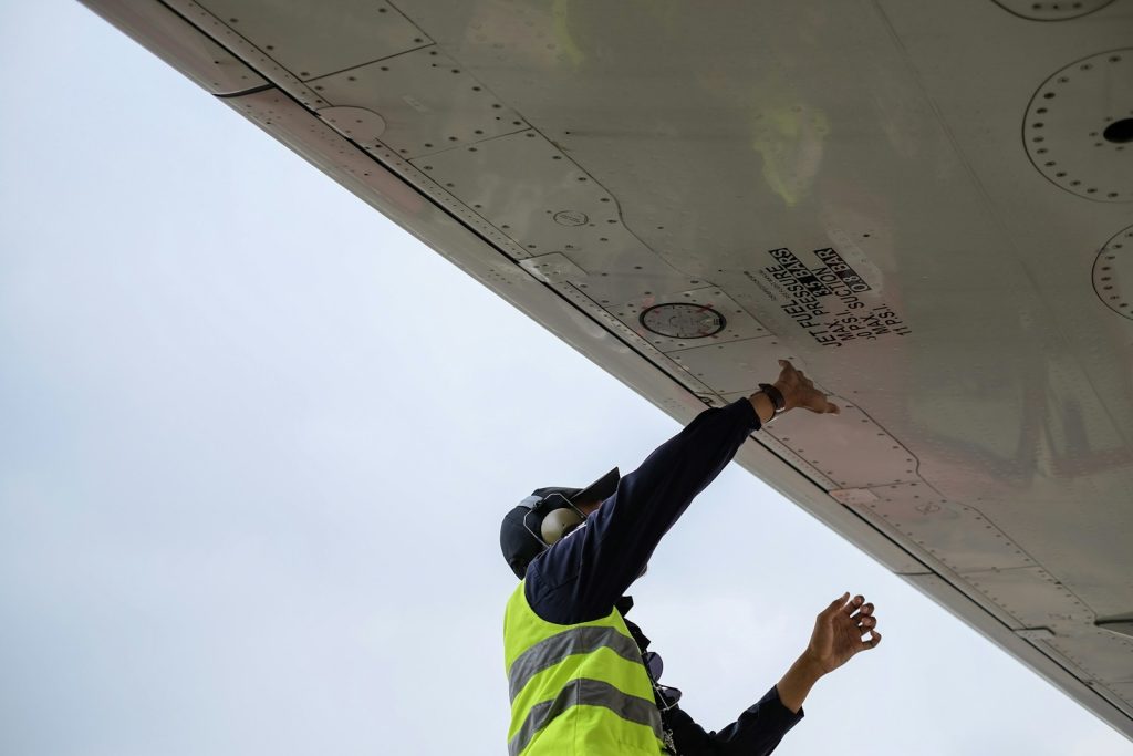 Aircraft engineer working beside an airplane on the tarmac