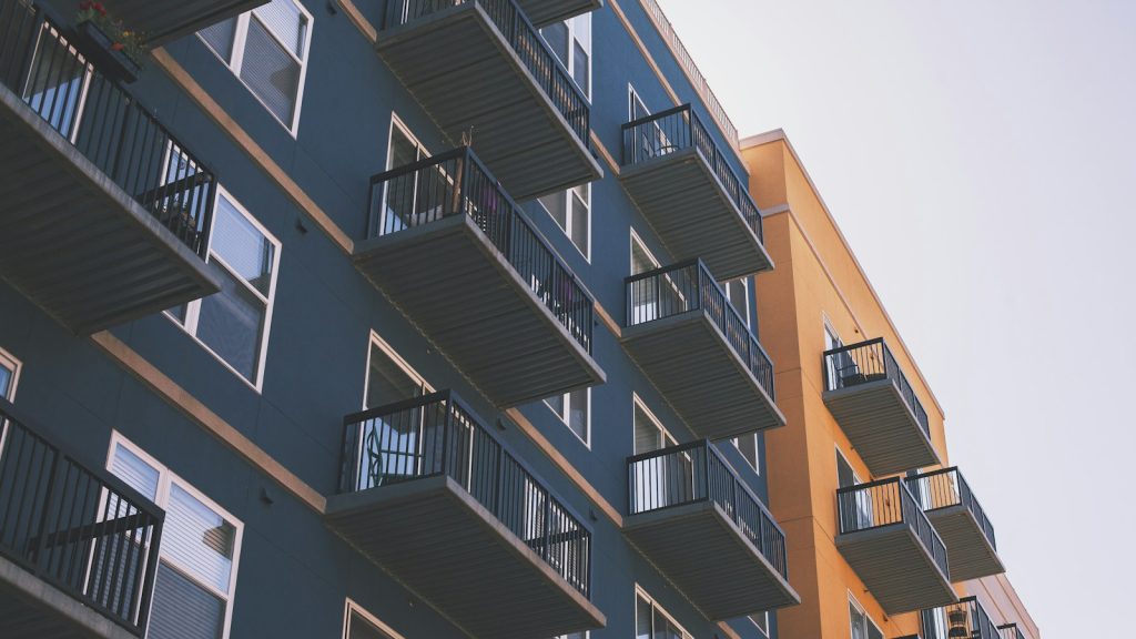 Blue and orange multi-unit apartment building with balconies