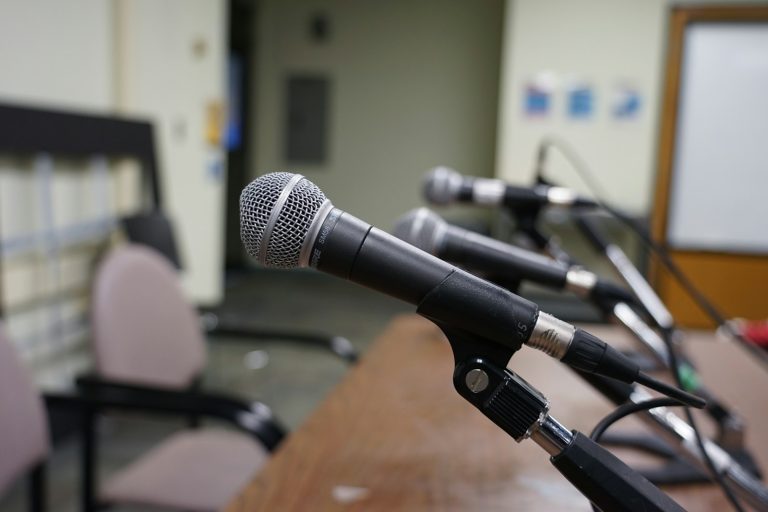 An unoccupied microphone on a stand, used as an illustration for election candidate coverage