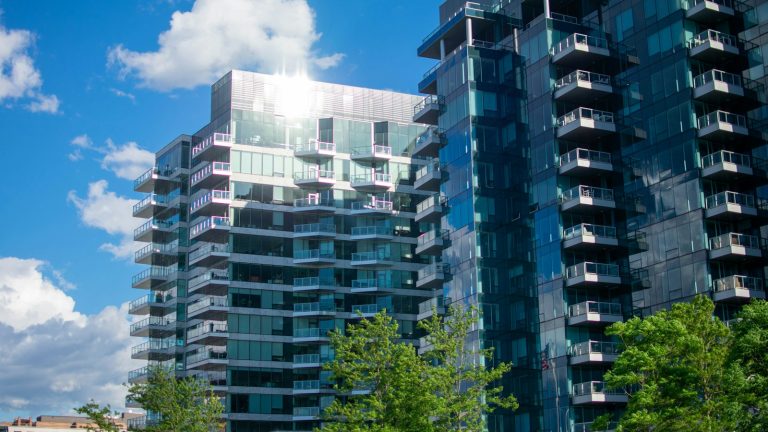 Modern high-rise residential buildings under a blue sky