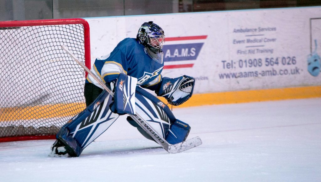 Hockey goaltender defending the net during a game