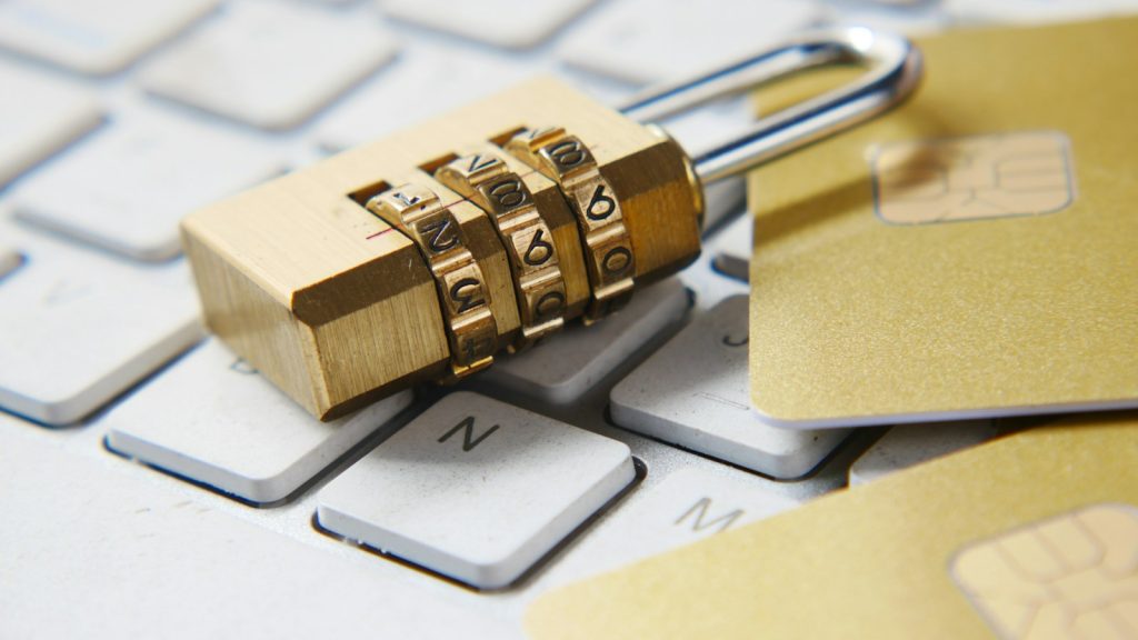 Gold combination padlock resting on a computer keyboard