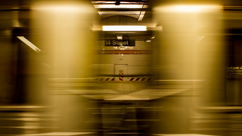 Subway train moving through an underground station