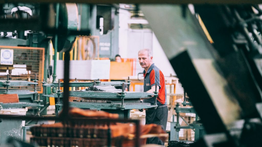 A worker operating machinery in an industrial facility
