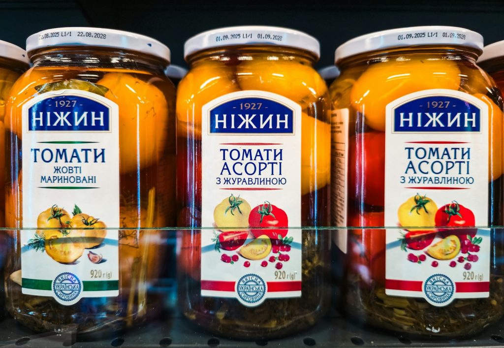 Jar of preserved tomatoes on a kitchen counter, illustrative stock image