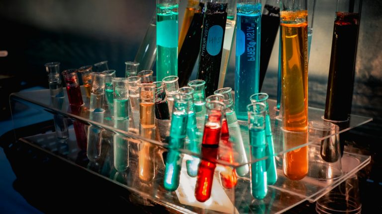 Colourful laboratory glassware arranged on a display rack
