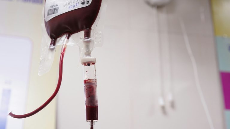 A medical blood bag and tubing in a clinical setting, illustrative image
