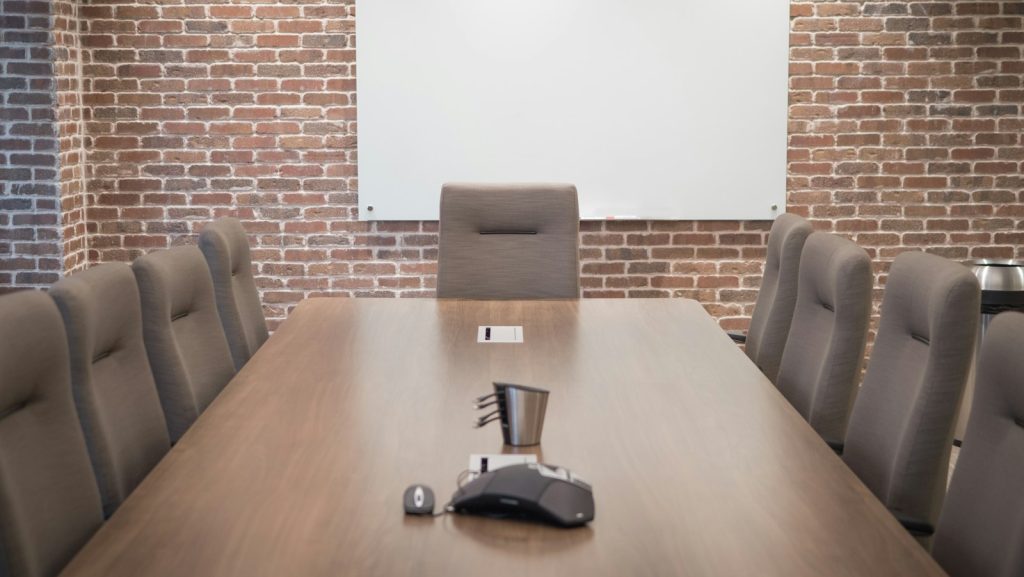 An empty modern meeting room with a large conference table