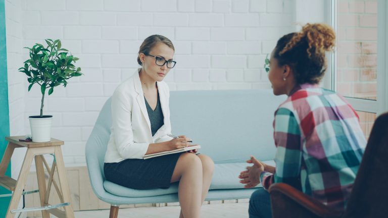 A counsellor listening during a mental-health consultation
