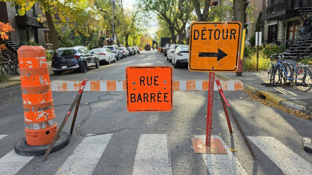 Orange French detour and road-closed signs on a Montréal residential street