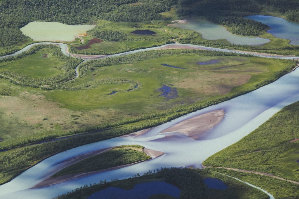 Wide river winding through northern forest, illustrating the Mackenzie River heritage process