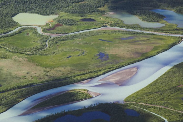 Wide river winding through northern forest, illustrating the Mackenzie River heritage process